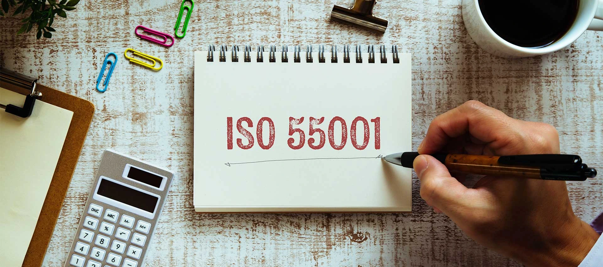 Notebook with ISO 55001 written